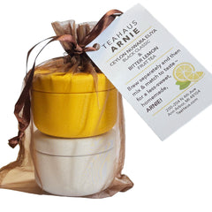Brown organza bag with yellow and white tins, labeled with info tag.