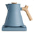 A matte slate blue electric kettle with a natural wood handle and lid knob, resting on a matching slate blue base against a white background.