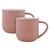 Two dusty rose porcelain mugs with white interiors.