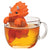 An orange triceratops infuser in a cup of tea
